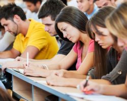 Group of college students in the university amphitheatre, they are sitting and doing an exam. The focus is on the brunette in pink t-shirt. 

[url=http://www.istockphoto.com/search/lightbox/9786738][img]http://dl.dropbox.com/u/40117171/group.jpg[/img]